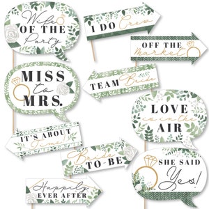 May include: Set of 10 green and white bridal shower photo booth props with gold accents. The props feature phrases like "Wife of the Party", "Miss to Mrs.", "I Do Crew", "Off the Market", "Team Bride", "It's About Time", "Love is in the Air", "Bride to Be", "Happily Ever After", and "She Said Yes!"
