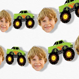 May include: A banner featuring green monster trucks with orange flames and black tires, interspersed with smiling children's faces. The trucks have black windows and are strung together with white string, creating a festive decoration.