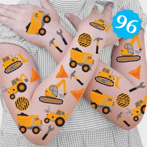 May include: A set of 96 temporary tattoos featuring construction vehicles, tools, and caution signs. The tattoos are yellow, orange, black, and gray. The tattoos are on a white background.