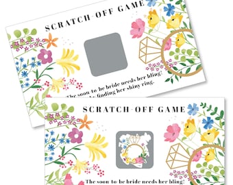 May include: Two white cards with a floral design and a gray scratch-off area. The text on the cards reads "Scratch-Off Game" and "The soon-to-be bride needs her bling! Win by finding her shiny ring."