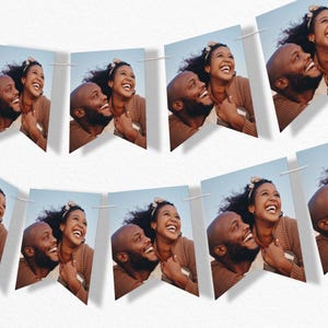 May include: A decorative banner consisting of multiple pennant-shaped flags strung together on a white cord. Each flag features a repeating photographic print of a smiling couple with dark hair, both wearing brown textured sweaters against a blue sky.