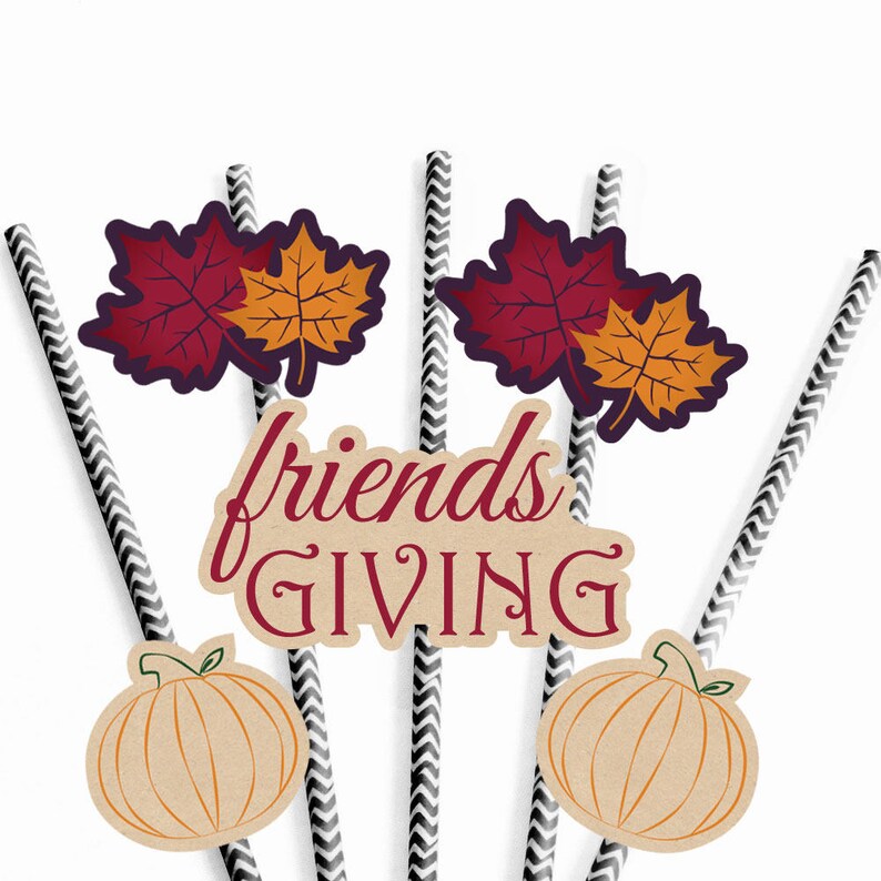 May include: Set of six black and white striped paper straws with fall-themed decorations. The decorations include two red and orange maple leaves, two brown pumpkins, and a brown sign that says "friends giving".