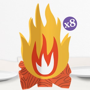May include: A decorative campfire centerpiece with yellow and red flames, orange logs, and a purple circle with the number 8. The campfire is designed to stand upright and is likely used for party decorations or themed events.
