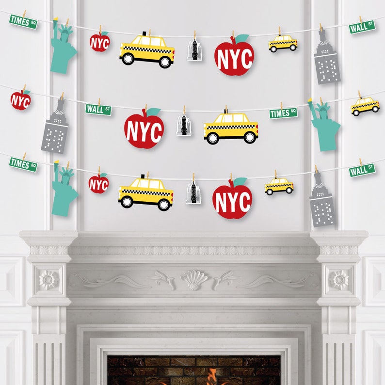 May include: A New York City themed party banner with red apples, yellow taxis, and gray buildings. The banner also includes the text "NYC", "TIMES SQ", and "WALL ST".