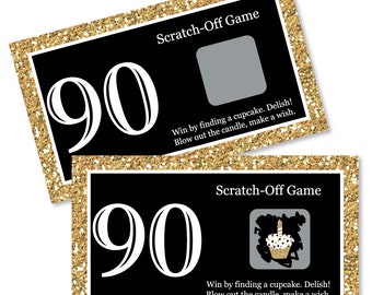 May include: Two black and gold scratch-off game cards with the number 90 printed in white. The text "Scratch-Off Game" is printed in white on both cards. The text "Win by finding a cupcake. Delish! Blow out the candle, make a wish." is printed in white on both cards.