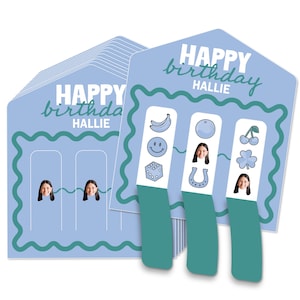 May include: Light blue birthday cards with the text "HAPPY birthday HALLIE". Each card has a teal border and a slot for a photo. Three teal bookmarks feature fruit, smiley faces, dice, and a photo.