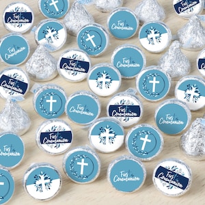 May include: Blue and white round stickers with the text "First Communion" and a cross design. The stickers are designed for use on chocolate kisses.