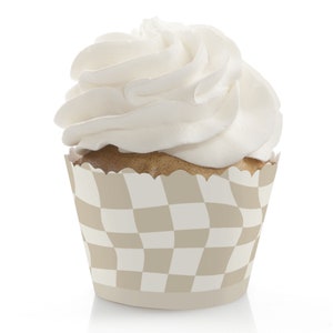 May include: A white cupcake with a swirl of frosting in a checkered cupcake liner. The liner is brown and white with a checkered pattern.