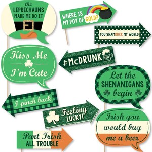 May include: Set of 10 green and white St. Patrick's Day photo booth props with sayings like "Kiss Me I'm Cute", "Let the Shenanigans Begin", and "Part Irish All Trouble".