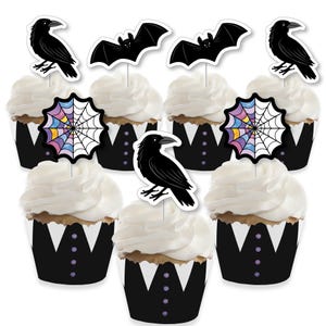 May include: Cupcakes with white frosting and black cupcake wrappers decorated with raven, bat, and spiderweb toppers. The cupcake wrappers have a tuxedo design with purple button accents. A festive treat for Halloween.