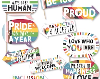 May include: A set of 10 colorful photo booth props with rainbow stripes and messages about pride, inclusion, and love. The messages include "So Many Ways to Be Human", "Be You", "Proud", "Pride 365 Days a Year", "Respected & Accepted", "Love Who You Are", "Your True Colors Are Beautiful", "Everyone is Welcome", "Inclusion Matters", and "We Exist in Happiness & Love".
