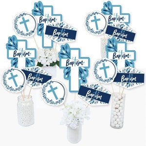 May include: Blue and white baptism centerpiece decorations with crosses, wreaths, and the word "Baptism" on each piece.