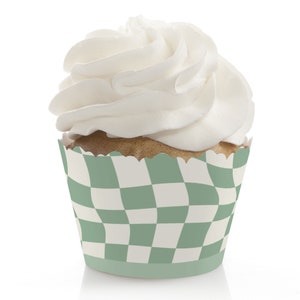 May include: Green and white checkered cupcake liner with a swirl of white frosting on top.