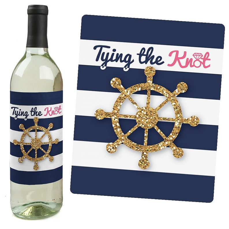 May include: A white wine bottle with a blue and white striped label that says "Tying the Knot" with a gold glitter ship wheel. The label also features a pink diamond ring.