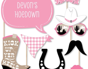 May include: Pink and brown cowboy boot photo booth prop with the text "Kick Up Yer Heels". Other props include a pink bandana, a pink speech bubble with the text "Devon's Hoedown", a pink bow tie, a white cowboy hat, pink sunglasses with a desert scene, a black mustache, a black horseshoe with the text "Lucky", and a pink lip.