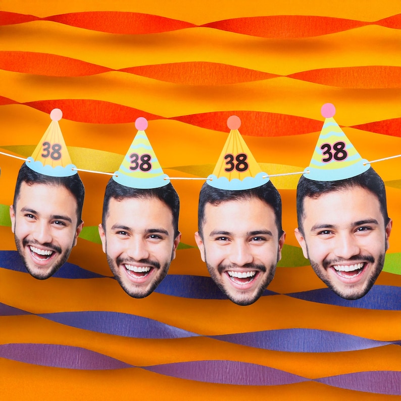 May include: A string of four smiling faces, each wearing a party hat with the number 38. The hats are yellow with a blue brim and a pink pom-pom. The background is orange and purple.