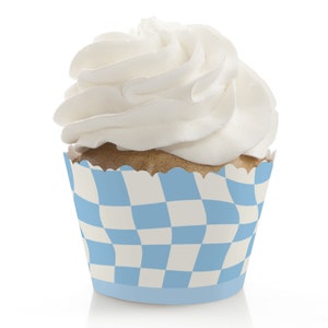 May include: Blue and white checkered cupcake liner with a swirl of white frosting on top.