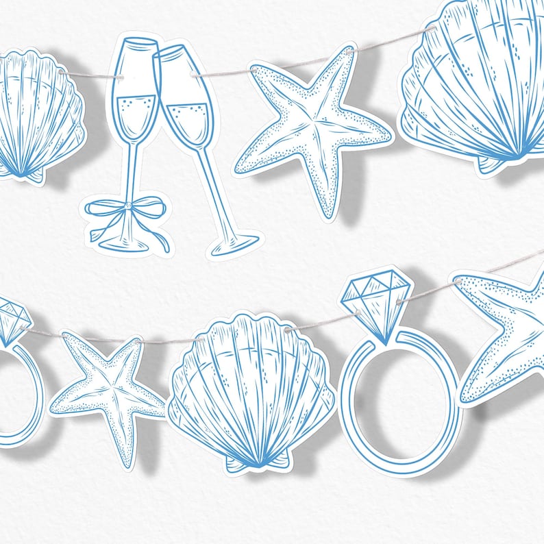 May include: A string of light blue paper cutouts featuring champagne flutes, seashells, starfish, and diamond rings. The decorations are strung on a thin, light-colored string, perfect for a beach-themed party or wedding.
