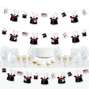 May include: A magic show party banner with black and white magician hats with bunny ears and red playing cards. The banner also has the words "Magic Show" printed on it.