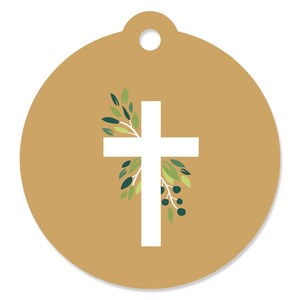 May include: A round, gold-colored tag with a white cross and green leaves. The tag has a hole at the top for hanging.