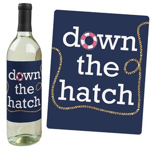 May include: A navy blue wine bottle label with a gold rope design and the text "down the hatch" with a pink life preserver graphic.