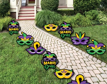 May include: A set of nine Mardi Gras yard signs featuring purple, green and gold masks and the text "Mardi Gras".