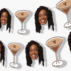 May include: A string of paper cutouts featuring a smiling woman's face and coffee martini glasses. The martini glasses are brown with coffee beans on top. The woman has dark curly hair and is smiling.