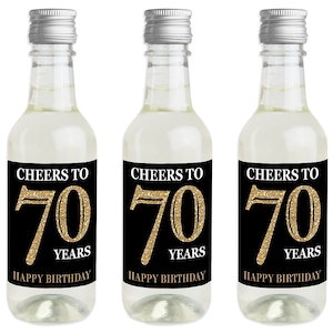 May include: Three mini wine bottles with black and gold labels that say "Cheers to 70 Years Happy Birthday".