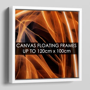 May include: Abstract art print with orange and yellow lines on a black background. The print is framed in a white floating frame. The text "CANVAS FLOATING FRAMES UP TO 120cm x 100cm" is printed on the frame.