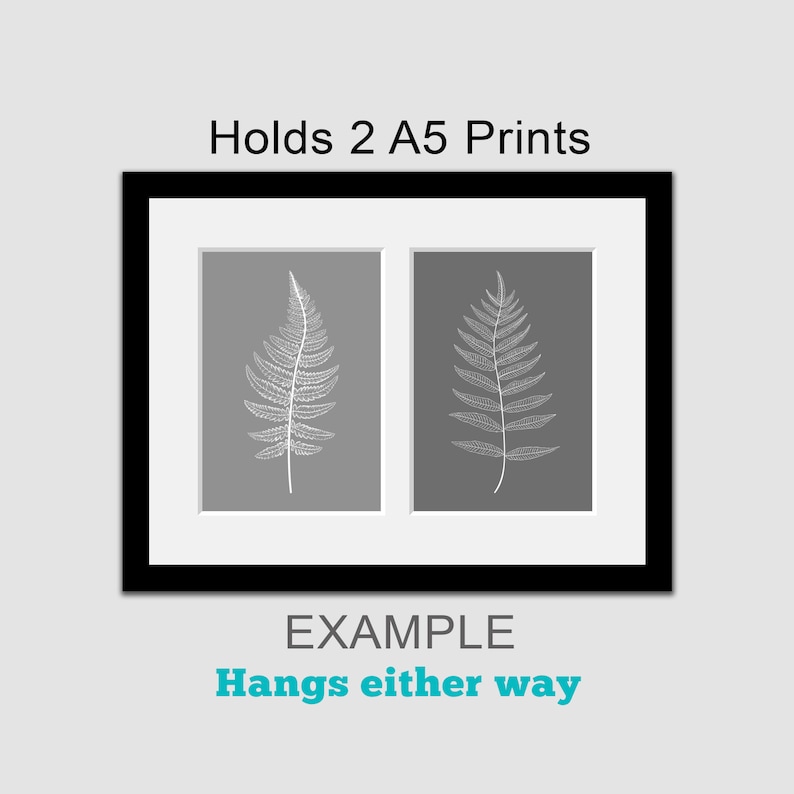 May include: Black picture frame with a white mat, holding two A5 prints of fern leaves on a gray background. The text "Holds 2 A5 Prints" is above the frame and "EXAMPLE" and "Hangs either way" are below the frame.