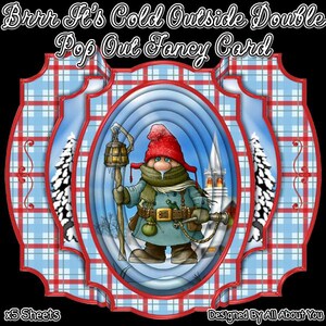 May include: A double pop-out fancy card with a winter theme. The card features a cartoon gnome with a red hat, holding a lantern and a staff. The background has a blue and white plaid pattern and a winter scene. The text "Brrr It's Cold Outside Double Pop Out Fancy Card" is at the top.