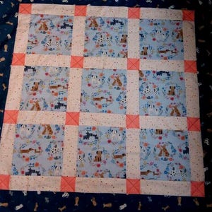 Patchwork Puppy Quilt with Dachshunds, Dalmatians, Scotties, and more in blues and peach, 38" Square