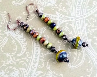 Beautiful Faceted Czech Beads in Colors of Browns, Greens and Blues Highlight this Pair of Copper Dangle Drop Earrings. NE275