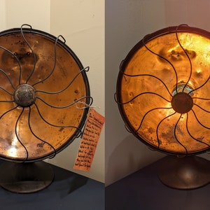 May include: A vintage copper and black electric heater with a wire cage and a round base. The heater has a label that reads "Simplex Electric Heating Co."
