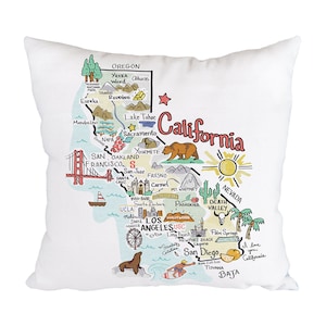 May include: A white throw pillow with a colorful illustration of the state of California. The illustration includes major cities, landmarks, and points of interest. The text "California" is written in a large, stylized font across the top of the pillow.