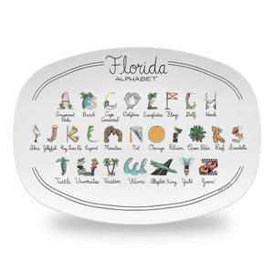 May include: White oval platter with the words "Florida ALPHABET" in black script. The platter features colorful illustrations of Florida landmarks and animals, each corresponding to a letter of the alphabet.
