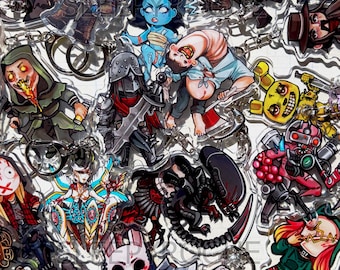 May include: A collection of clear acrylic keychains featuring various illustrated horror and fantasy characters, including a red-masked oni, a blue-skinned figure, a knight in armor, a xenomorph, and a rabbit-masked character holding an axe.