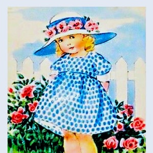 Puede incluir: Una niña pequeña con un vestido azul de lunares blancos y un sombrero blanco con flores rosas se encuentra frente a una valla blanca. Está rodeada de rosas rosas.
