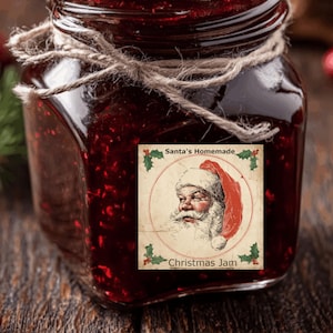 May include: A jar of Christmas jam with a label featuring Santa Claus. The jar is filled with a dark red, chunky preserve and tied with twine. The label reads "Santa's Homemade" and "Christmas Jam".
