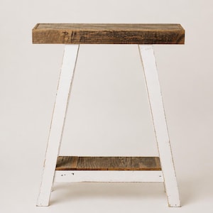 May include: A rustic wooden sign with the text "Welcome to our home" in white lettering. The sign features a distressed finish and a simple, inviting design, perfect for entryway decor.