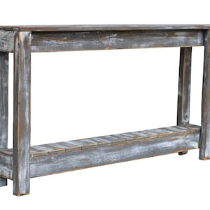 May include: A rustic wooden console table with a distressed gray finish. The table has a single shelf and a rectangular top.