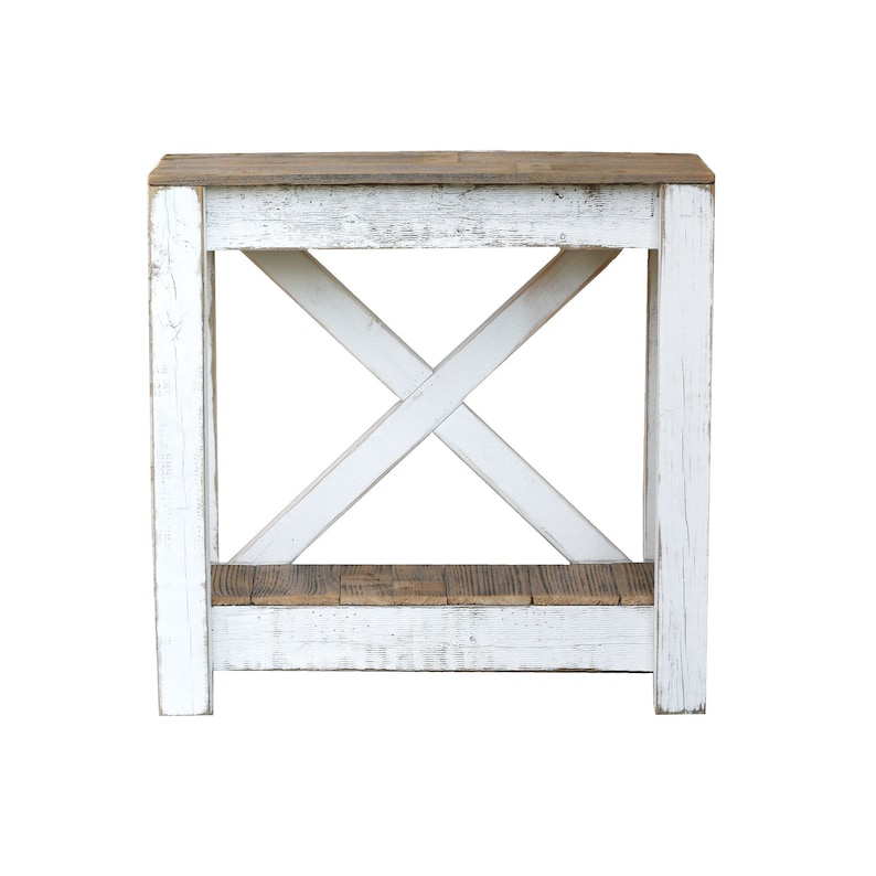 May include: White farmhouse style end table with a distressed wood finish and a lower shelf. The table has a simple X-shaped design on the front.