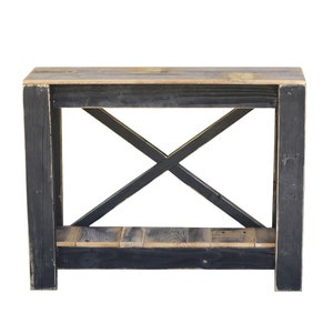 May include: A black wooden console table with a distressed finish. The table has a single shelf and an X-shaped support structure.