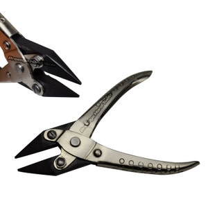 May include: A pair of metal pliers with black jaws, and the text "Prestige Hand Tools" printed on the handle. The pliers have a curved handle with a series of small circular indentations.