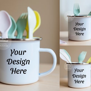 May include: White enamel mug with a handle, featuring the text "Your Design Here". The mug is filled with colorful plastic utensils, including a spoon, fork, and knife.