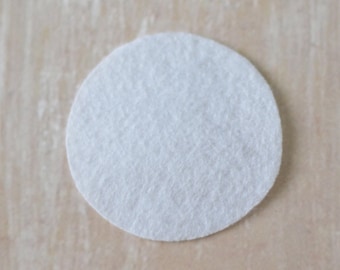 May include: A white round felt circle.