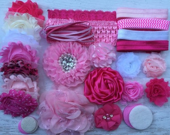 May include: A collection of pink and white fabric flowers, headbands, and hair ties. The flowers are made of various materials, including lace, satin, and tulle. The headbands are made of elastic and are decorated with ribbons and bows. The hair ties are made of elastic and are decorated with beads and rhinestones.