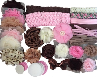 May include: A set of brown, pink, and cream-colored fabric headbands with various embellishments, including flowers, bows, and polka dots.