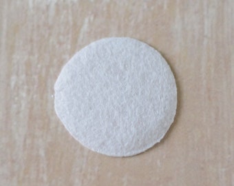 May include: A white round coffee filter, commonly used for brewing coffee.