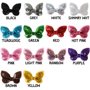 May include: Twelve butterfly-shaped sequin hair clips in various colours, including black, grey, white, turquoise, green, red, hot pink, pink, light pink, rainbow, purple, brown, and yellow.